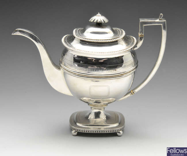A George III silver teapot on pedestal base.