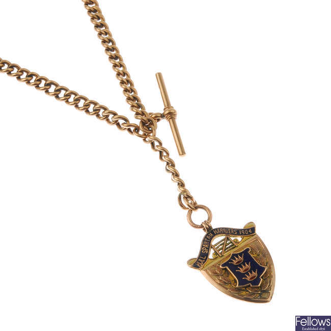An early 20th century 9ct gold Albert chain, suspending a shield medallion.