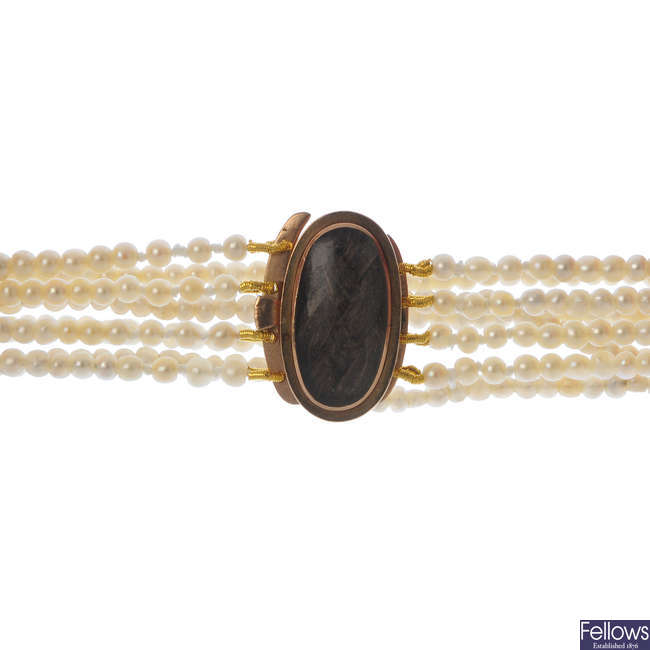 A mid Victorian seed pearl four-row bracelet, with gold mourning clasp.
