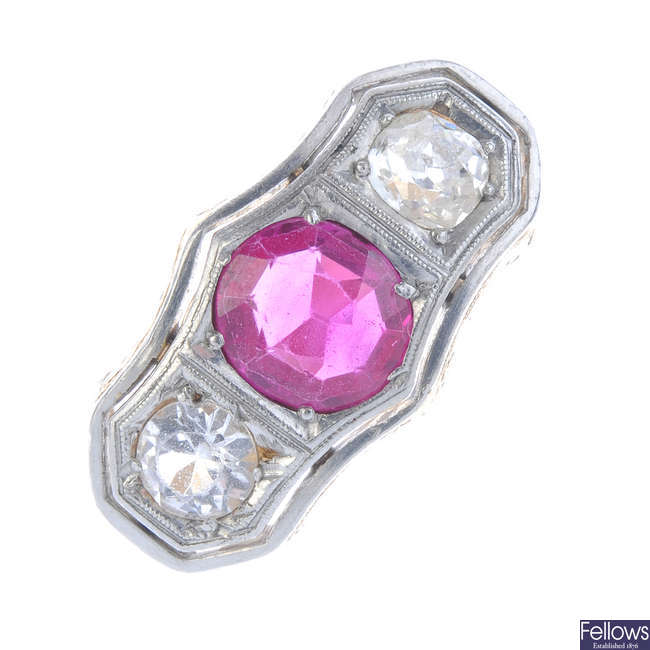 A diamond, synthetic ruby and sapphire three-stone ring.