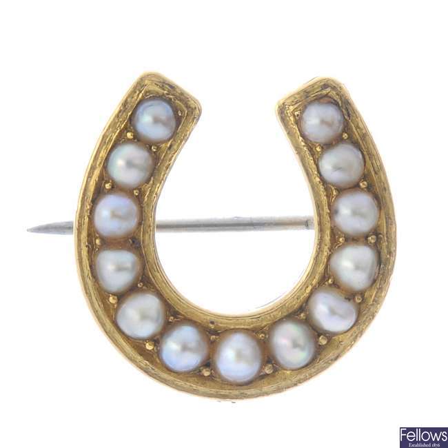 A late Victorian gold split pearl horseshoe brooch, circa 1880.