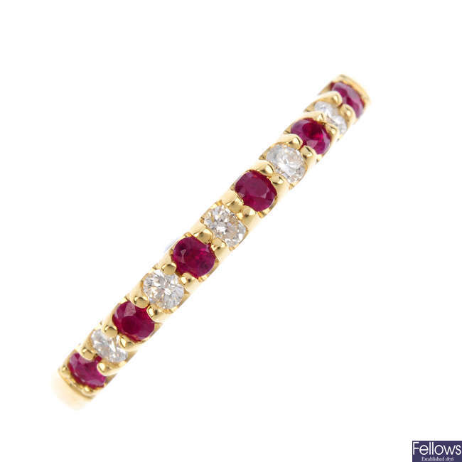 An 18ct gold diamond and ruby half-circle eternity ring.