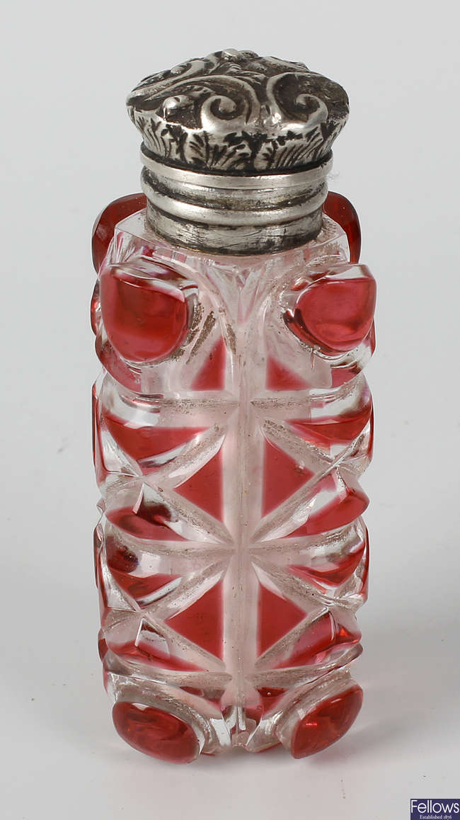 A Victorian cranberry and clear glass bodied scent bottle.