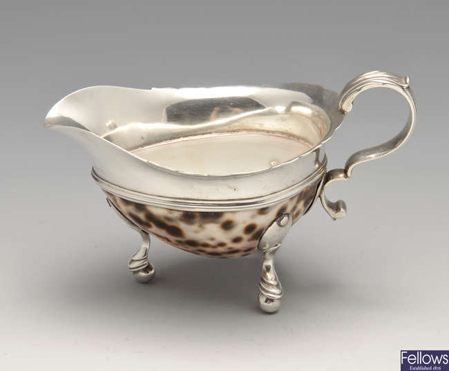 A cowrie shell mounted sauce boat.
