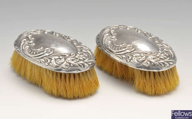 A pair of Edwardian silver mounted clothes brushes, etc.