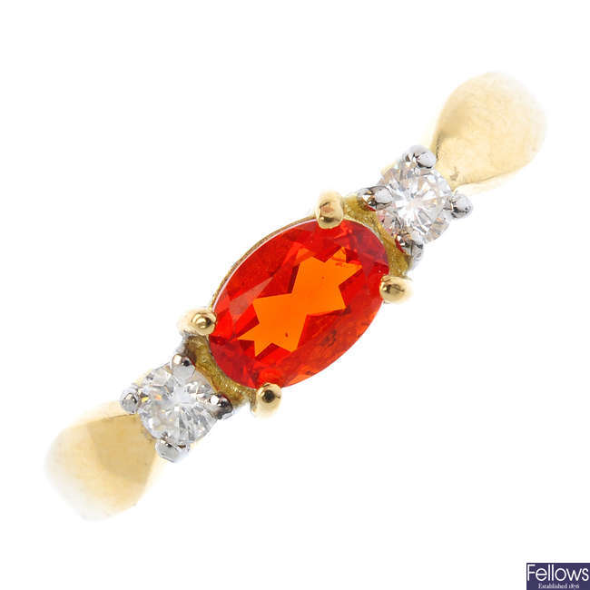 An 18ct gold fire opal and diamond three-stone ring.