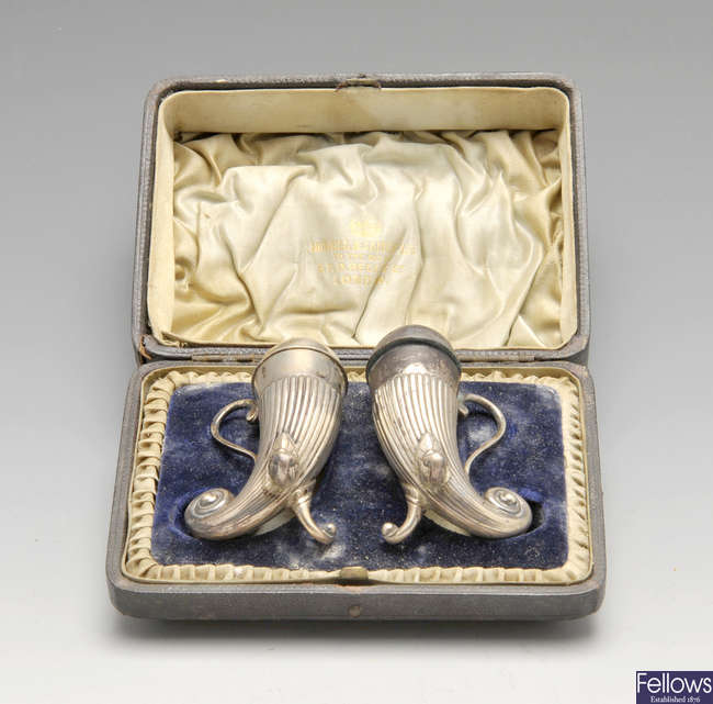 A cased pair of late Victorian silver casters.