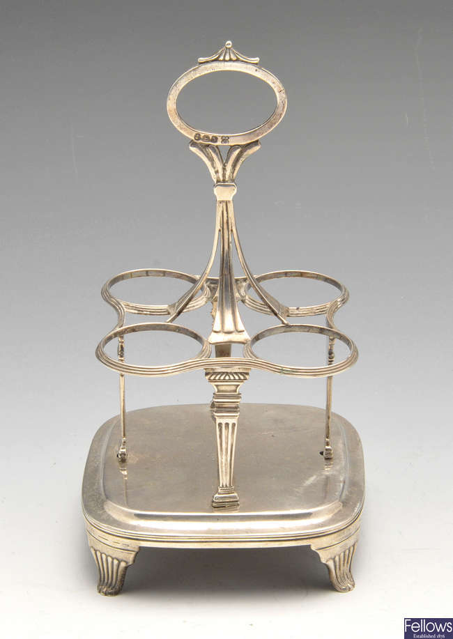 A George III silver bottle cruet stand.