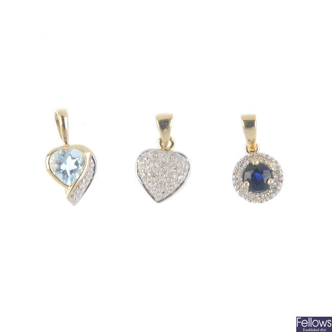 Three gem-set pendants.