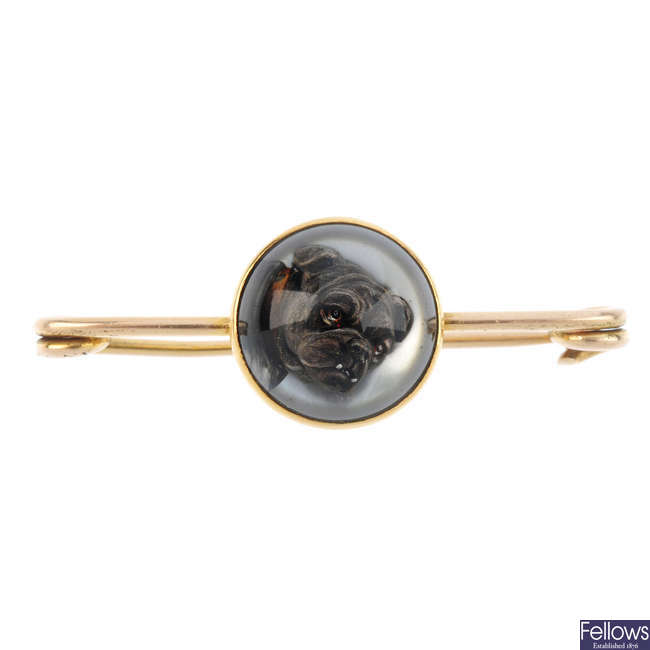 An early 20th century gold rock crystal reverse-carved intaglio brooch.