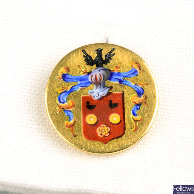 A pair of early 20th century gold enamel cufflinks, depicting a coat of arms.