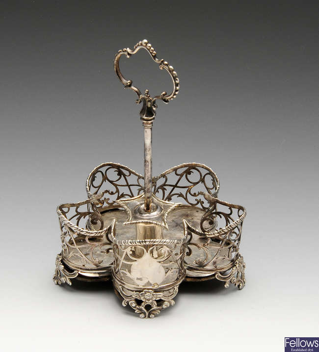 A George III silver five bottle cruet stand.