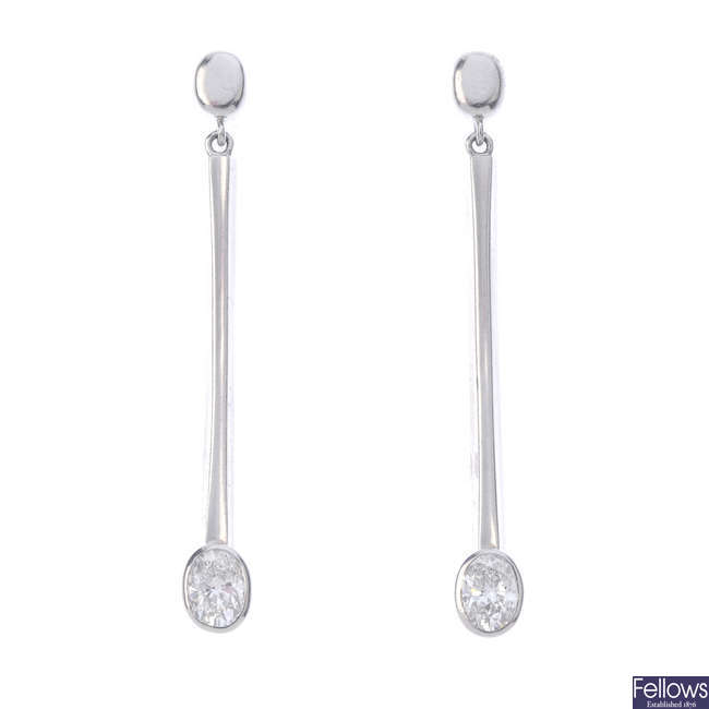 A pair of platinum diamond earrings.