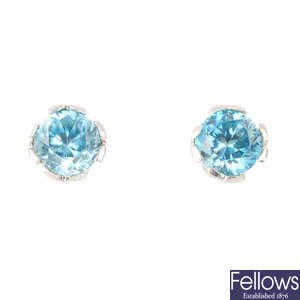 A pair of zircon and diamond stud earrings.