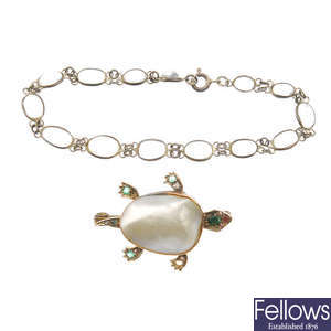 A turtle brooch and a moonstone bracelet.