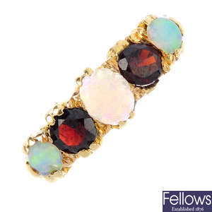 A late Victorian 18ct gold garnet and opal five-stone ring.