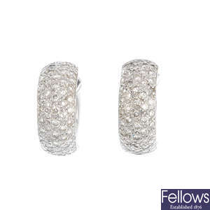 A pair of diamond hoop earrings.