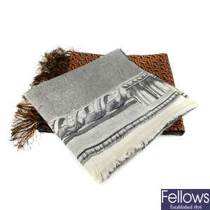 A selection of designer scarves, a silk scarf and lace place mats.