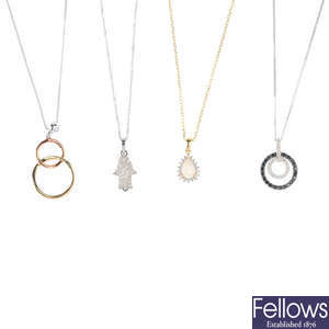 Four diamond and gem-set pendants, with chains.
