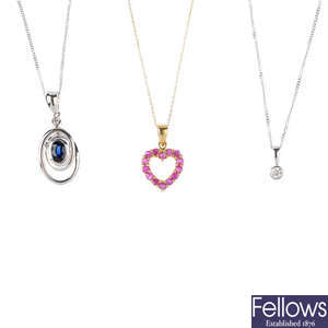 Five diamond and gem-set pendants, with chains.