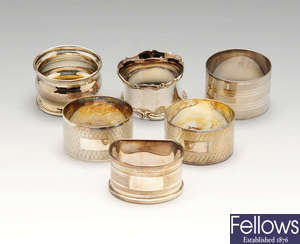 A selection of silver napkin rings, trinket box, spoons, etc & a small quantity of plated items.
