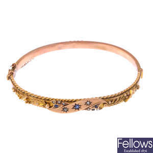 An Edwardian 9ct gold gem-set bangle.