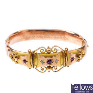 An Edwardian 9ct gold ruby and diamond hinged bangle.