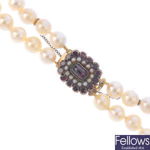 A cultured pearl necklace with late 19th century 9ct gold garnet and split pearl clasp.