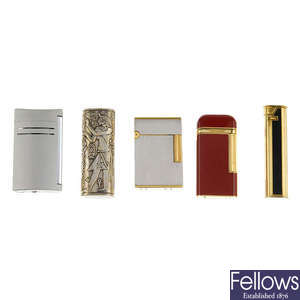 A selection of four designer lighters and a lighter cover.