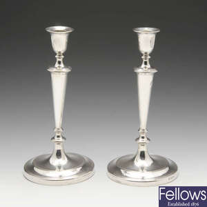 A pair of late Victorian silver candlesticks with filled bases.