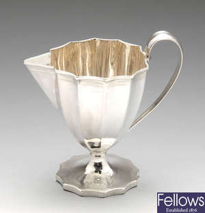 A George III silver pedestal cream jug.