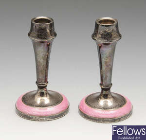 A pair of small 1930's silver & pink enamel candlesticks.