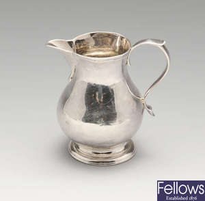 A George II sparrow beak cream jug & Victorian example.