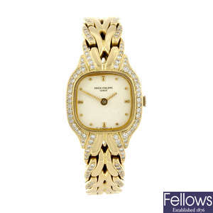 PATEK PHILIPPE - a lady's factory diamond set 18ct yellow gold La Flamme bracelet watch.