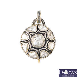 A foil-back diamond and diamond pendant.