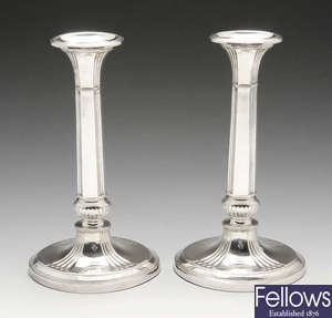 A pair of Edwardian silver filled candlesticks.