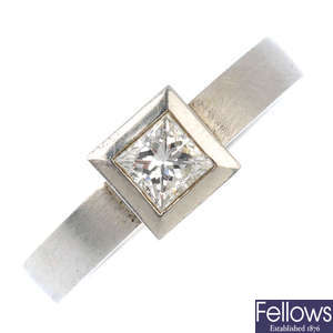 A platinum square-shape diamond single-stone ring. 