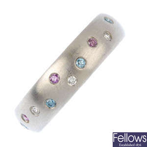 A platinum diamond and colour treated diamond band ring.