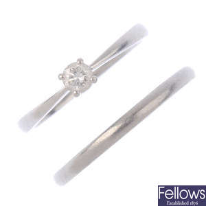 A platinum diamond single-stone ring and a band ring.