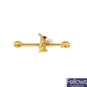 An early 20th century 9ct gold seed pearl rabbit bar brooch.