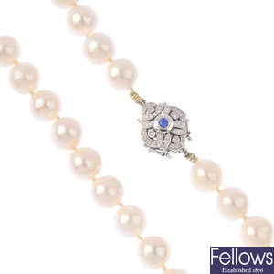 A cultured pearl single-strand necklace, with sapphire and diamond clasp.