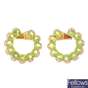 A pair of peridot and diamond earrings.