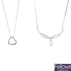 Five diamond and gem-set pendants with chains.