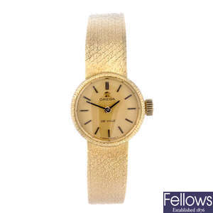 OMEGA - a lady's yellow metal De Ville bracelet watch.