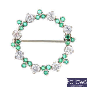 An emerald and cubic zirconia brooch.