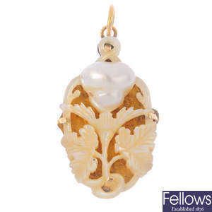 An early 20th century 18ct gold carved mother-of-pearl and blister pearl pendant. 