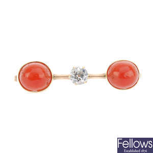 A gold coral and diamond brooch.