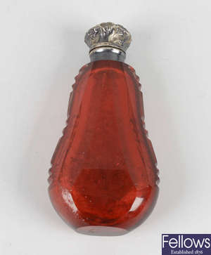 A Victorian cranberry glass scent bottle.