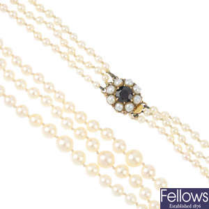 A three-row cultured pearl necklace, with gold clasp. 
