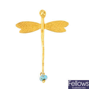 A turquoise dragonfly brooch.